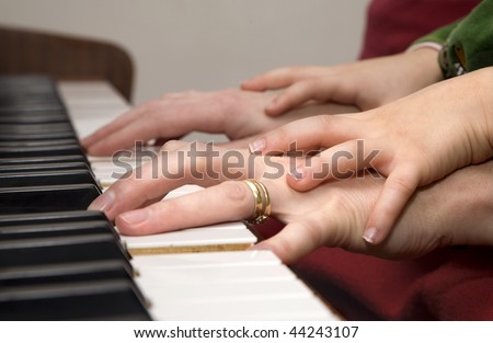 hands of piano player and the child