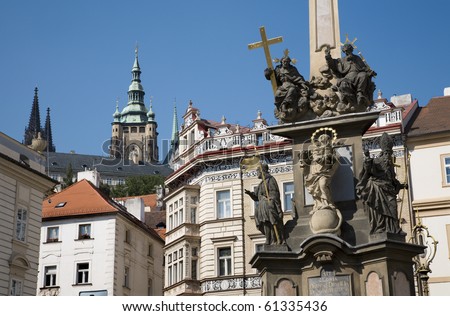 Prague - baroque column of Holy Trinity and tower of st. Vitus cathedral