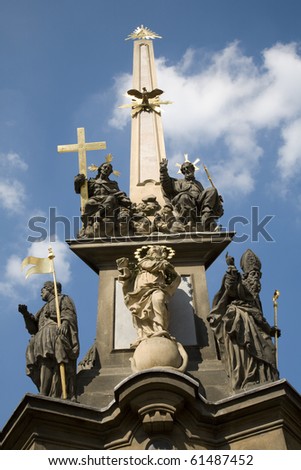 Prague - baroque column of Holy Trinity and tower of st. Vitus cathedral - infront of St Nicolas Church at Lesser Town Square - 1713, by Giovanni Batista Alliprandi