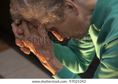 meditation of old woman at candle light