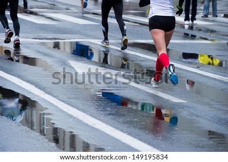 Young woman running with forwards arrow on the road.