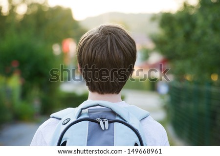 Teen wearing a school bag heading to school Teen wearing a school bag heading to school
