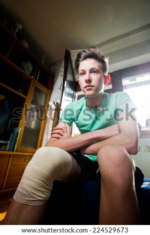 Teenager with a bandaged knee.