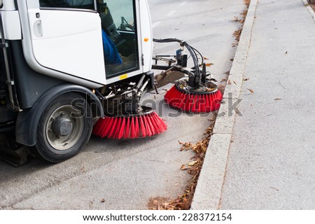 Vehicle sweeping the streets of dirt.