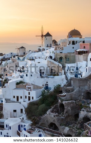 Vibrant sunset over houses and villas at Oia Santorini Greece