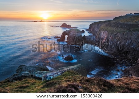Sunset at Lands End Cornwall England UK showing the rock formations of Enys Dodman and the Armed Knight