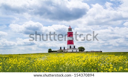 Colourful field and Happisburgh Lighthouse North Norfolk England UK Europe