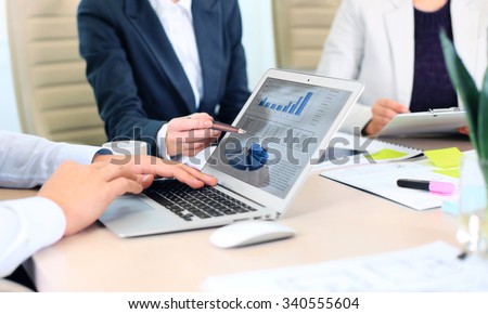 Business adviser analyzing financial figures denoting the progress in the work of the company