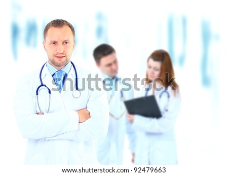 Portrait doctor smiling with colleagues in background