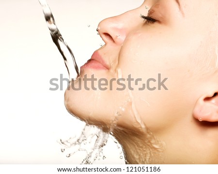 Young sensuality beautiful woman with clean skin with splash of water - white  background