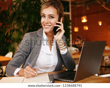 Happy  woman using chatting with mobile and use laptop computer and  working  at cafe restaurant,Digital age lifestyle,Working outside office concept.
