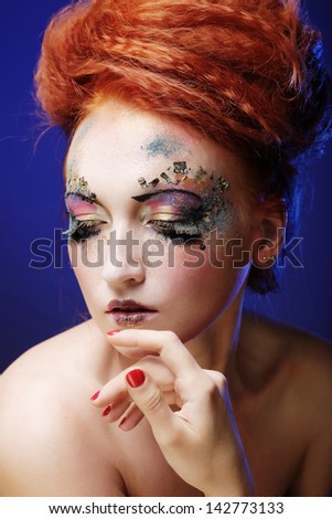 portrait of woman with artistic make-up over smoke background