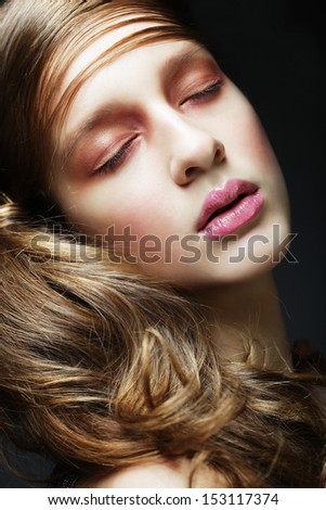Portrait of beautiful  woman with long blond curly hair. Bridal hairstyle.