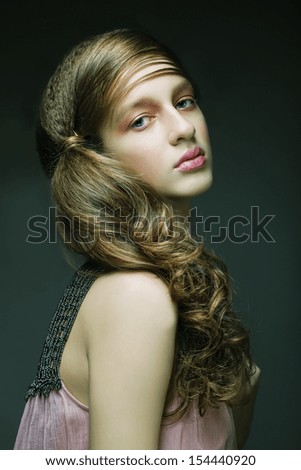 Portrait of beautiful  woman with long blond curly hair. Bridal hairstyle.