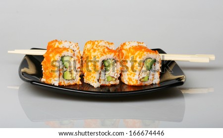 japanese  rolls on black plate. good food.