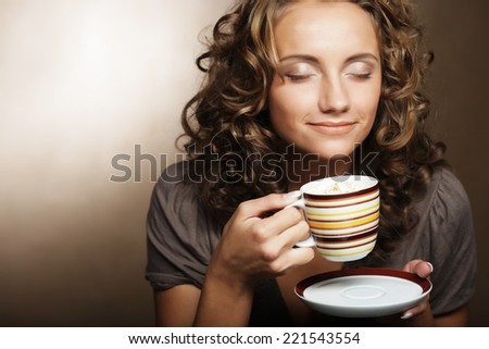 Beautiful young girl drinking tea or coffee Beautiful young girl drinking tea or coffee