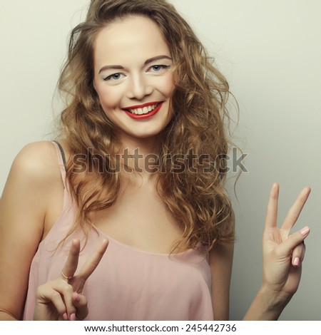 young expression woman over gray background, happy time