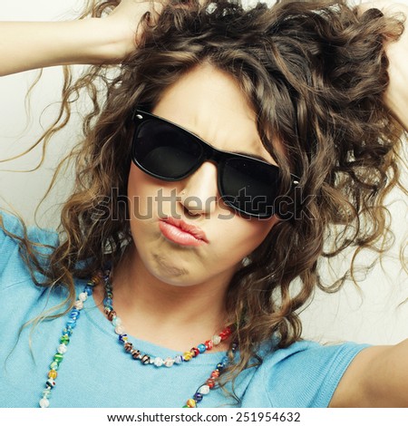 happy teen girl with sunglasses over white background