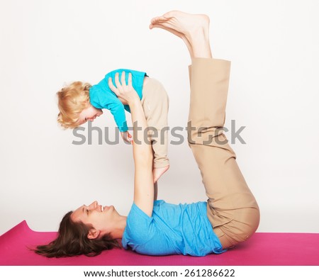 father holding his little son on his feet, yoga, happy family
