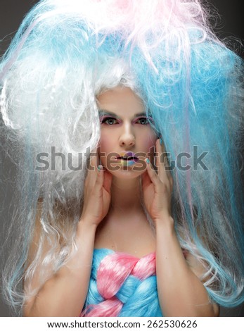 Young fashion model with bright make up and colorful hair
