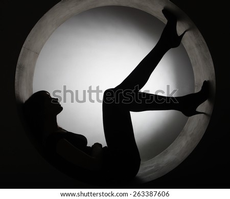 stylish silhouette beautiful woman in circle, studio shot