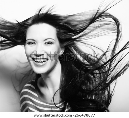 Young happy woman with wind in hair