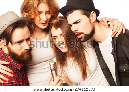 People, friendship  and leisure concept: group of young happy friends  having fun at karaoke, hipster style.Isolated on white.