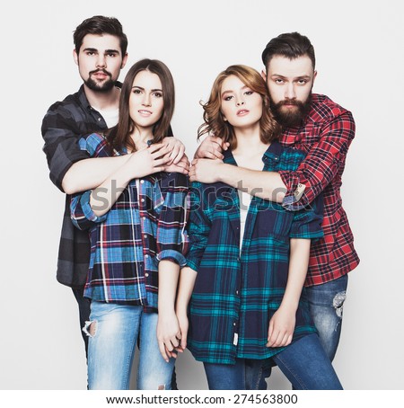 life style, happiness and people concept: attractive group of happy young men and women. Hipster style. Studio shot over white background. Special Fashionable toning.