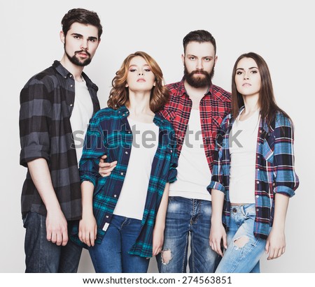 life style, happiness and people concept: attractive group of happy young men and women. Hipster style. Studio shot over white background. Special Fashionable toning.