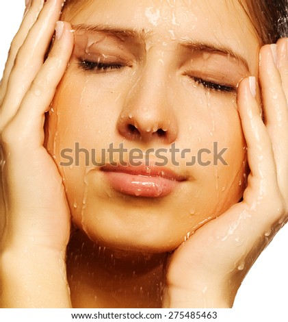 Close-up of beautiful wet woman face with water drop. On white background