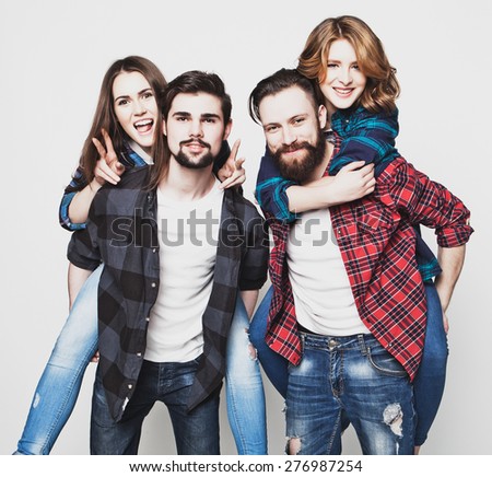 emotional, happiness and people concept: Group Of Young People Giving Piggybacks over white background.Special Fashionable toning photos.