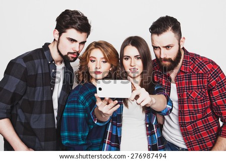 education, technology and people concept: group of students taking selfie with smartphone  over white background.Special Fashionable toning.