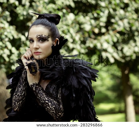 Dark Queen in park. Fantasy black dress.
