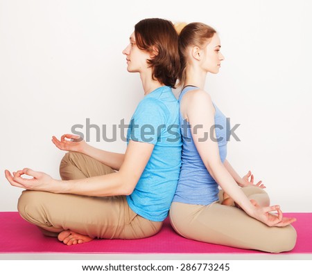 Young couple in yoga pose, happy family