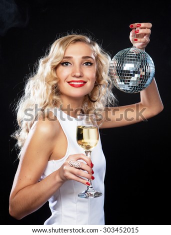 beautiful blond woman in evening dress with wine and disco ball