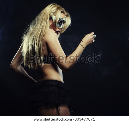 young sexy woman in black lingerie wearing mask