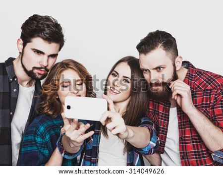 education, technology and people concept: group of students taking selfie with smartphone  over white background.Special Fashionable toning.