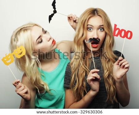 two stylish sexy hipster girls best friends ready for party, over gray background