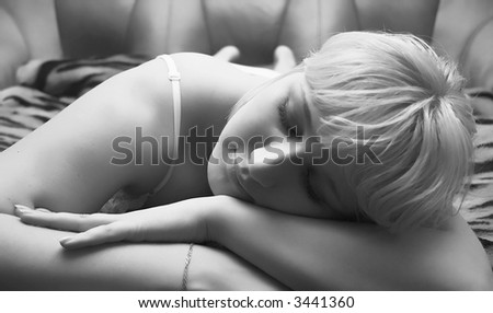 blondy young girl, woman sleeping on a sofa