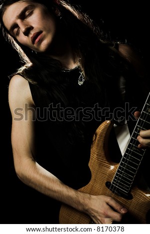 http://image.shutterstock.com/display_pic_with_logo/81677/81677,1199256567,1/stock-photo-man-with-long-hair-playing-electrical-guitar-8170378.jpg