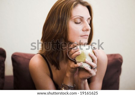 Portrait of young beautiful happy woman with tea