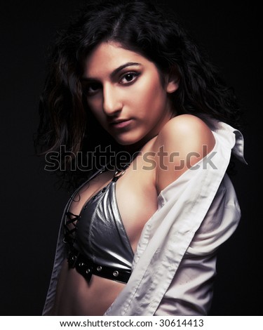 young brunette woman dance on black background