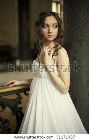 Portrait of a beautiful young victorian lady in white  dress