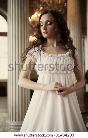 Portrait of a beautiful young victorian lady in white  dress