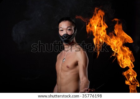 young asian man with fire show