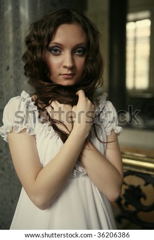 Portrait of a beautiful young victorian lady in white dress