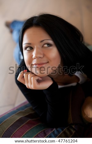 Beautiful woman sitting and  smiling indoors