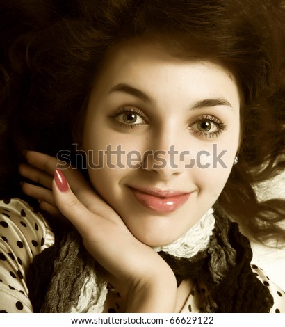 dark curly hair green eyes. stock photo : Young woman with long rown curly hair and green eyes laying
