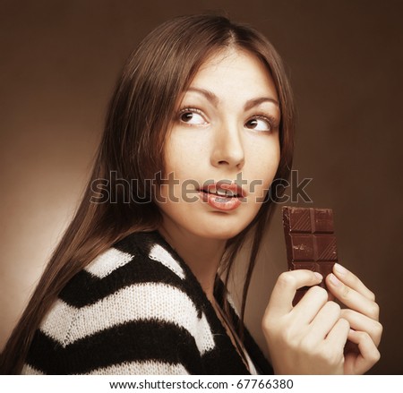 Cheerful woman eating chocolate