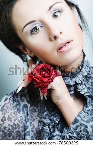 beautiful woman with natural make-up  with hand wearing big flower ring.